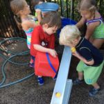 preschoolers playing with ball and ramp